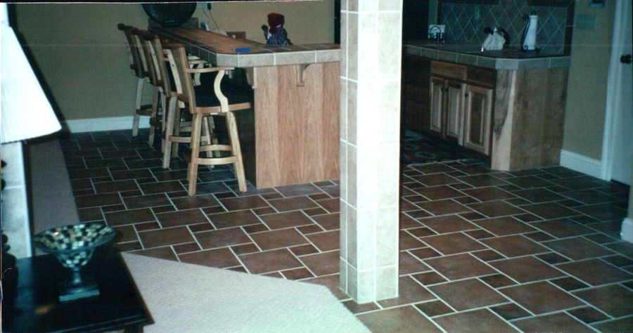 Terracotta brick pattern tile floor through a kitchen and bar