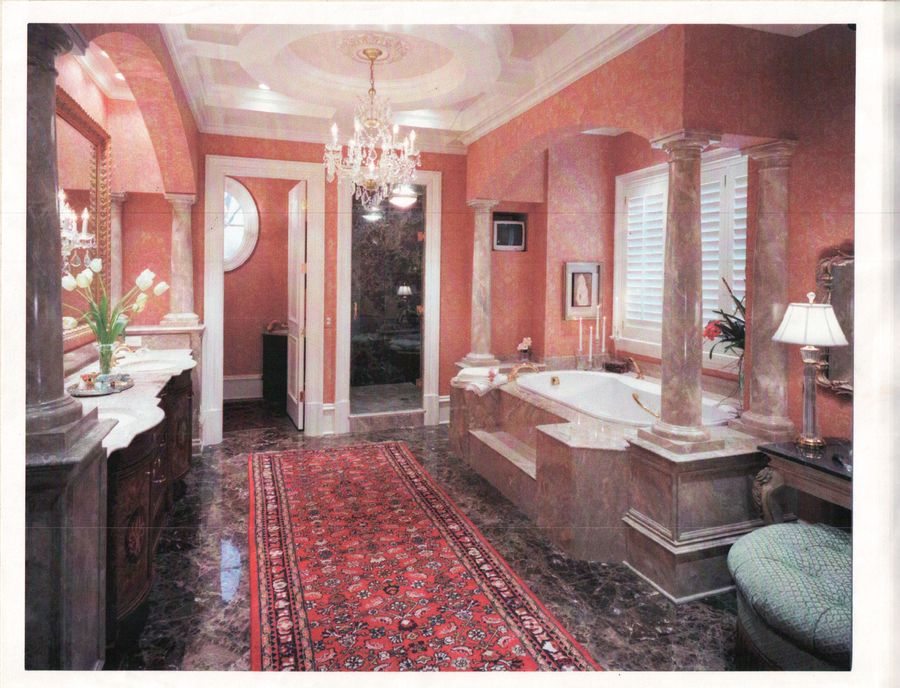 Grand master bathroom with marble columns and tub surround