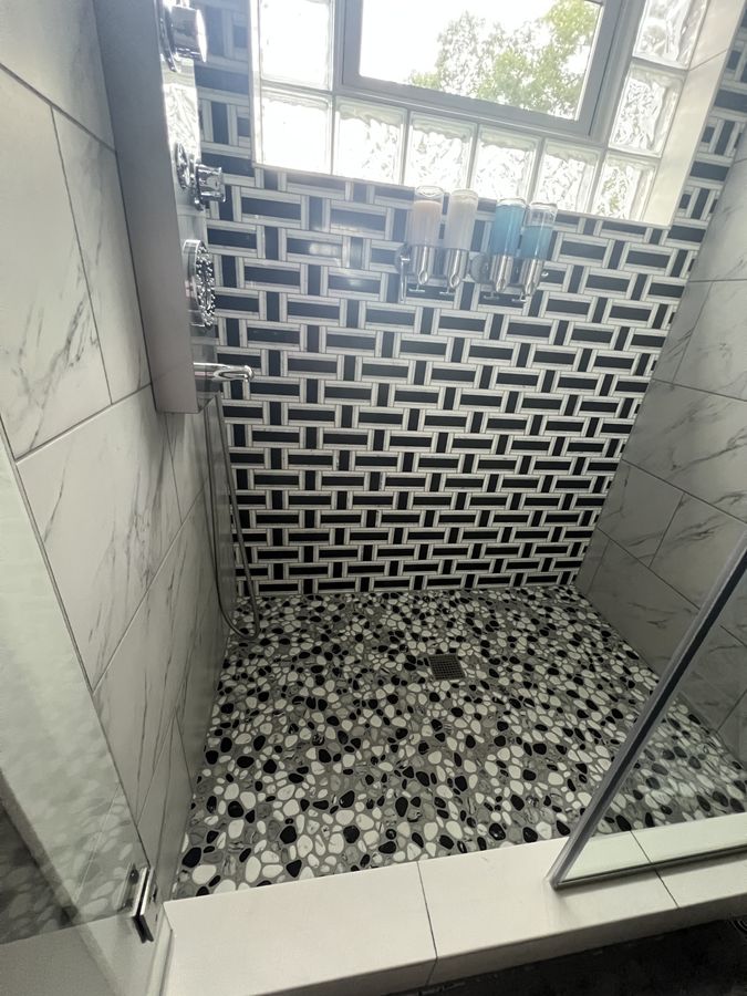 Basket weave shower with black and white pebble pan