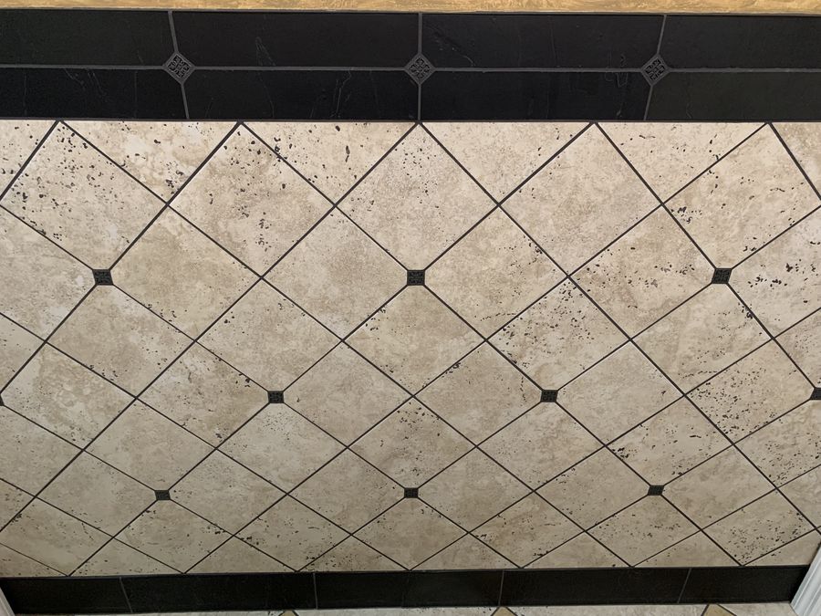 Diagonal travertine floor with black dot inserts and border