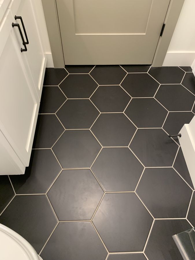 Guest bath with white picket shower and black hex floor