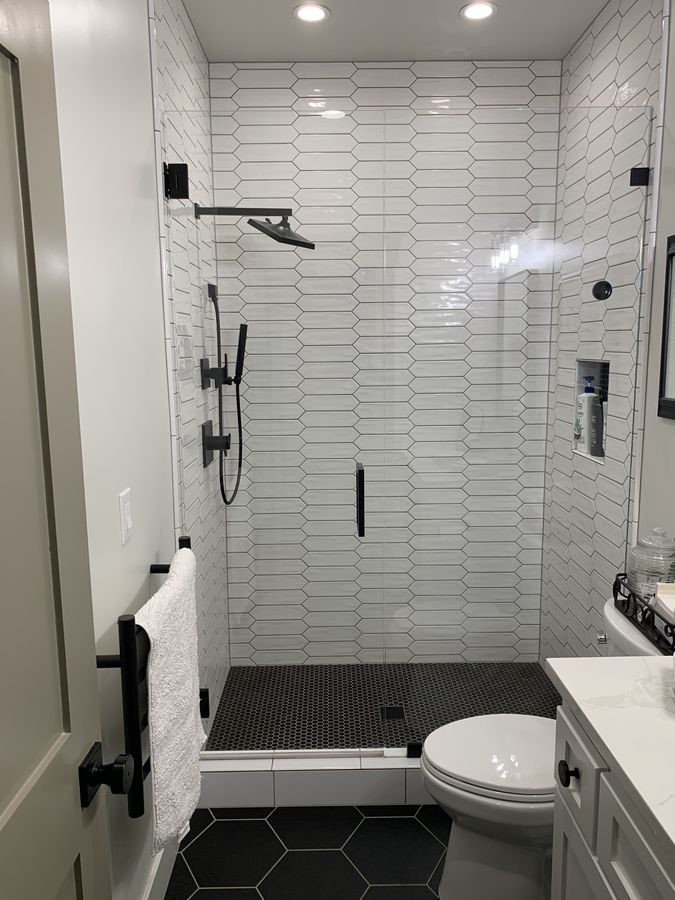 Picket tile carried across the shower ceiling with recessed vent