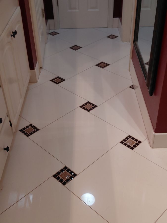 White diagonal floor tile with inset mosaic dot detail